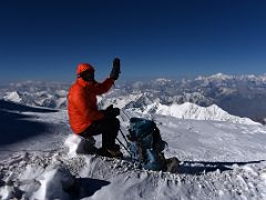 07B Taking a rest at about 6800m with a mountain panorama beyond on the way to the Lenin Peak summit